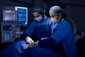 Female surgeons operating patient at hospital