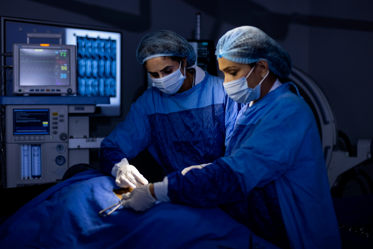 Female surgeons operating patient at hospital